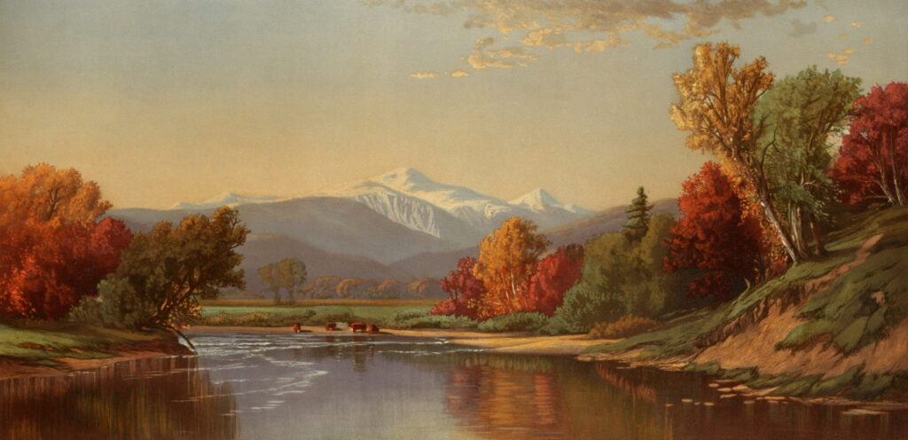 A river bends between red and gold trees toward a snowy mountain.