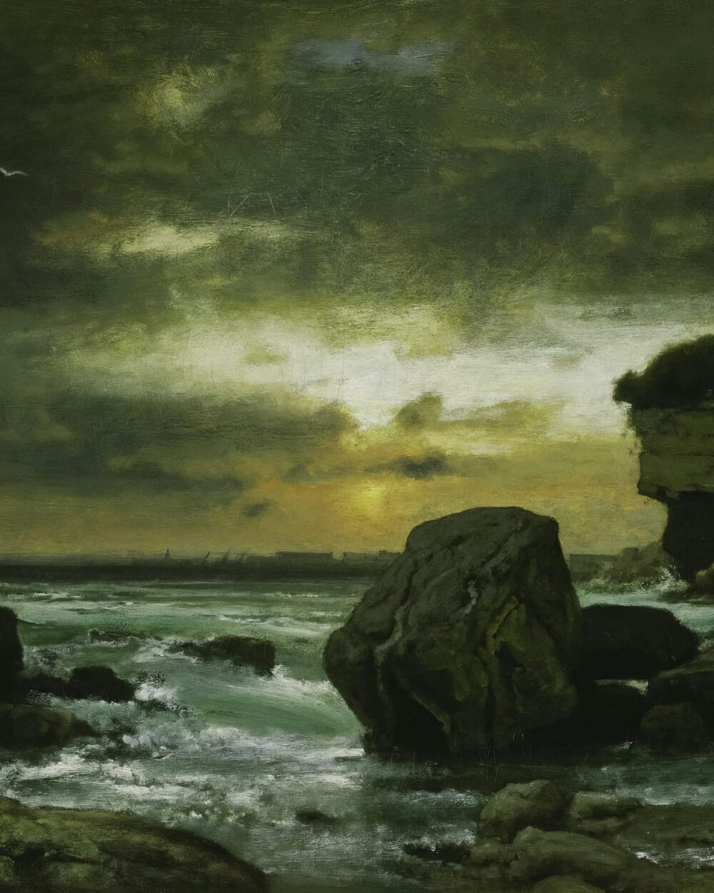 A green storm light over a rocky bay, with a pale break in the clouds.