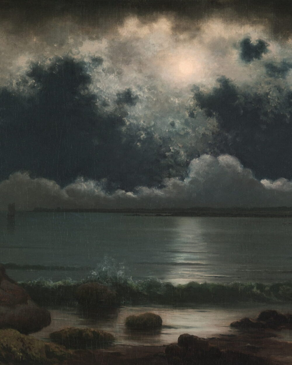 A full moon behind a wall of dark clouds above a quiet shore.