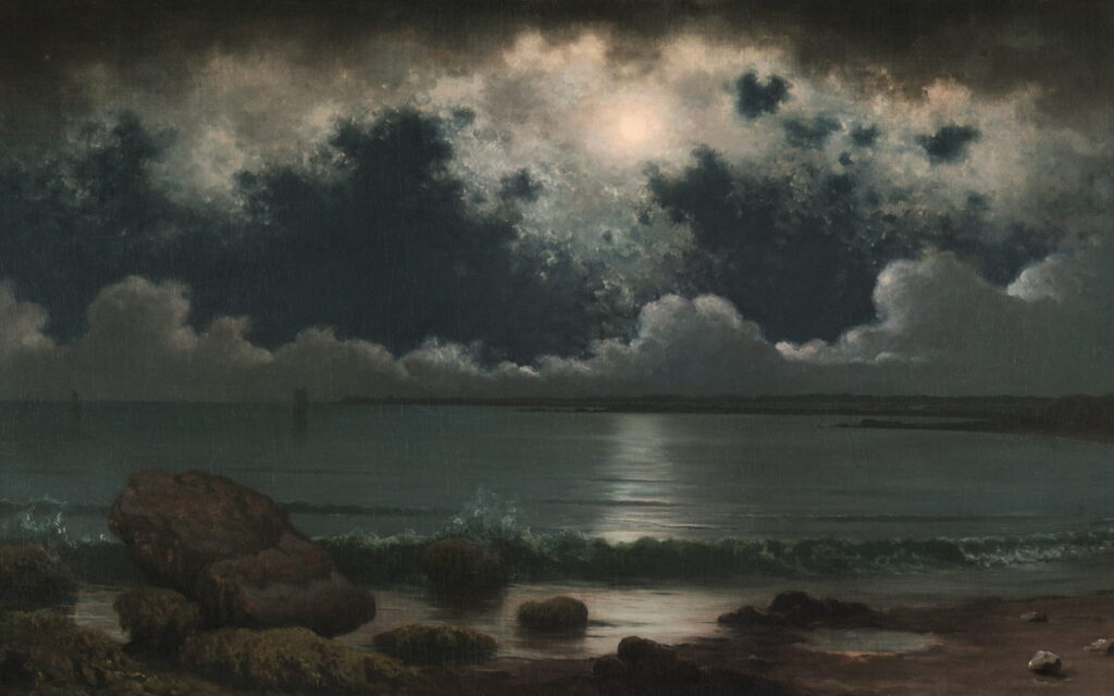 A full moon behind a wall of dark clouds above a quiet shore.
