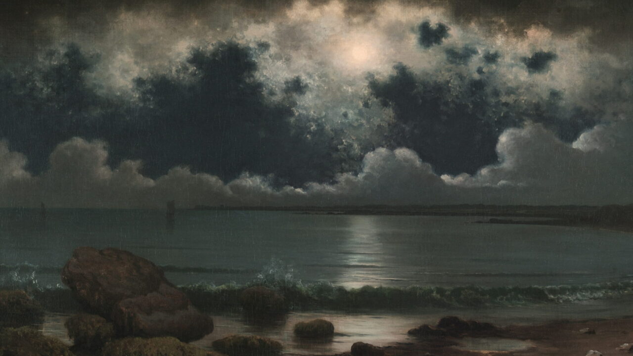 A full moon behind a wall of dark clouds above a quiet shore.