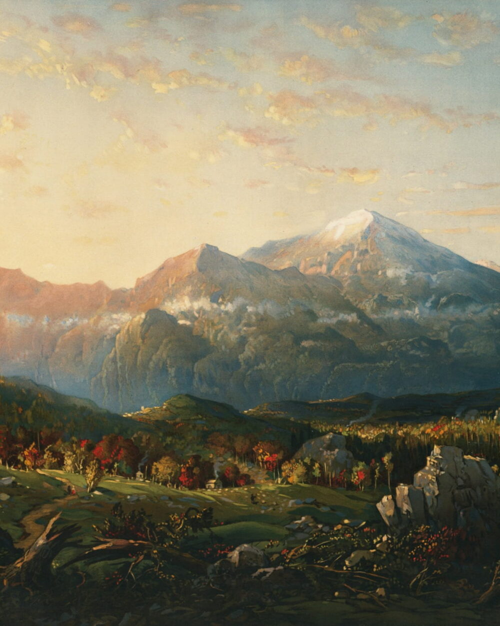 Morning light reaches a snowy peak above an autumn valley.