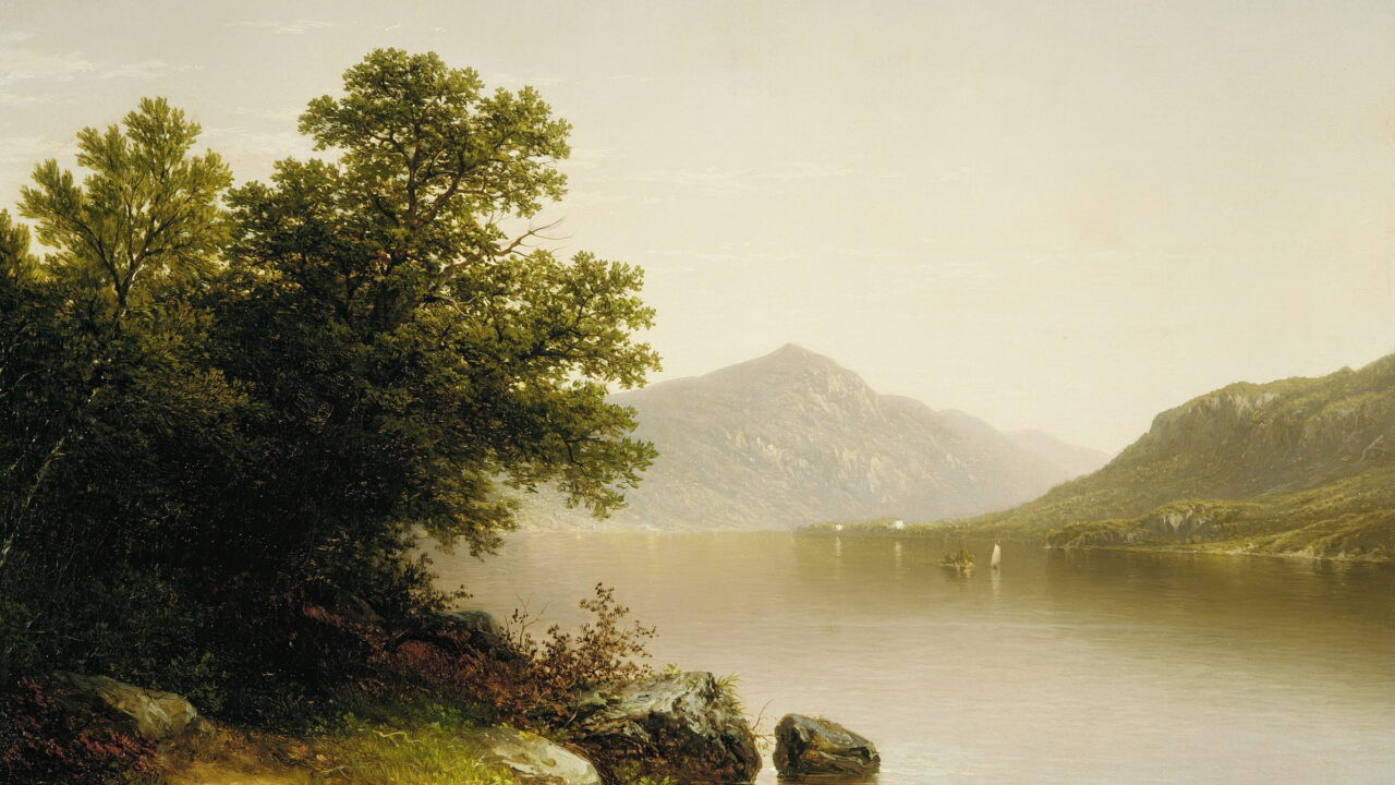 A quiet lake reflects far mountains, with one small sail on the water.