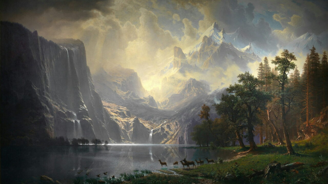 Waterfalls fall from tall cliffs into a mountain lake under a bright storm sky.
