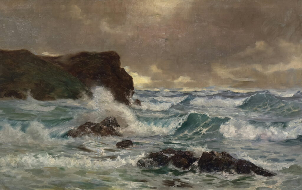 Gray waves break over dark rocks below a low, heavy sky.