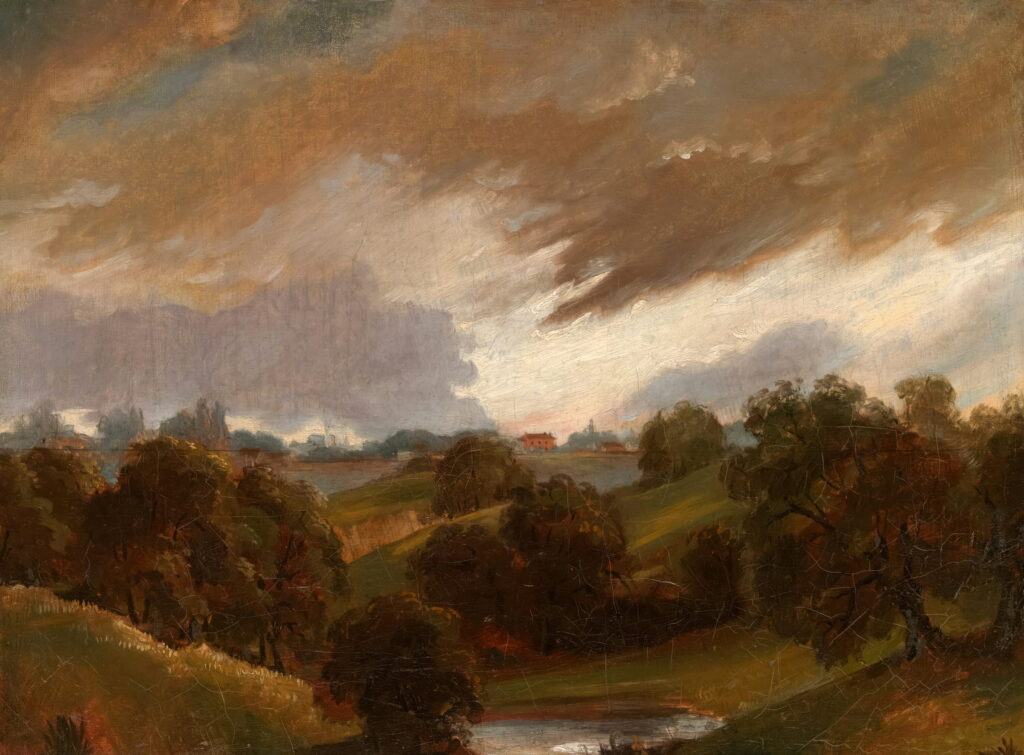 Brown storm clouds roll over wooded hills and a far valley.