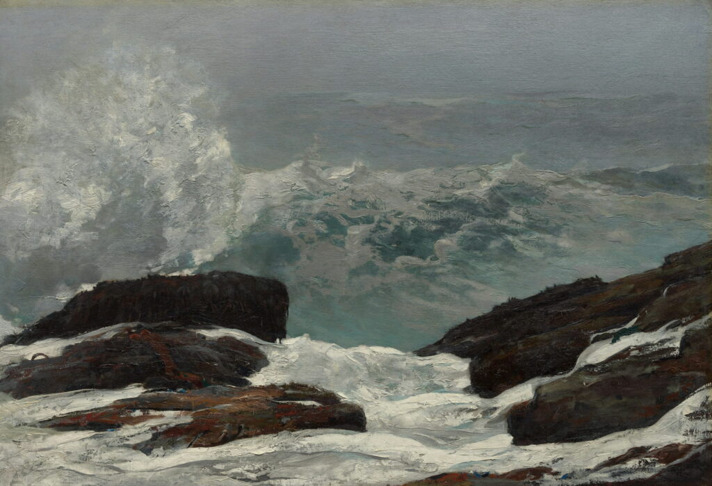 Surf pours between two dark rocks while spray rises behind them.
