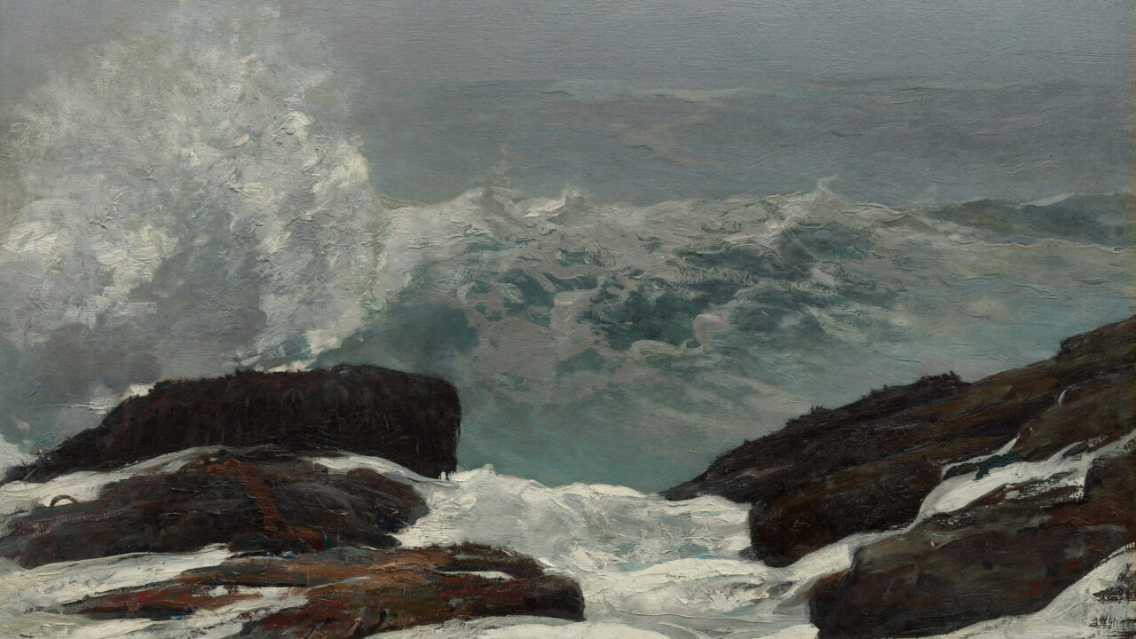 Surf pours between two dark rocks while spray rises behind them.