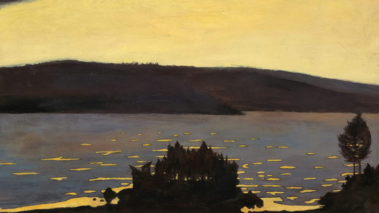 A yellow dusk sky over a dark lake with a small wooded island.
