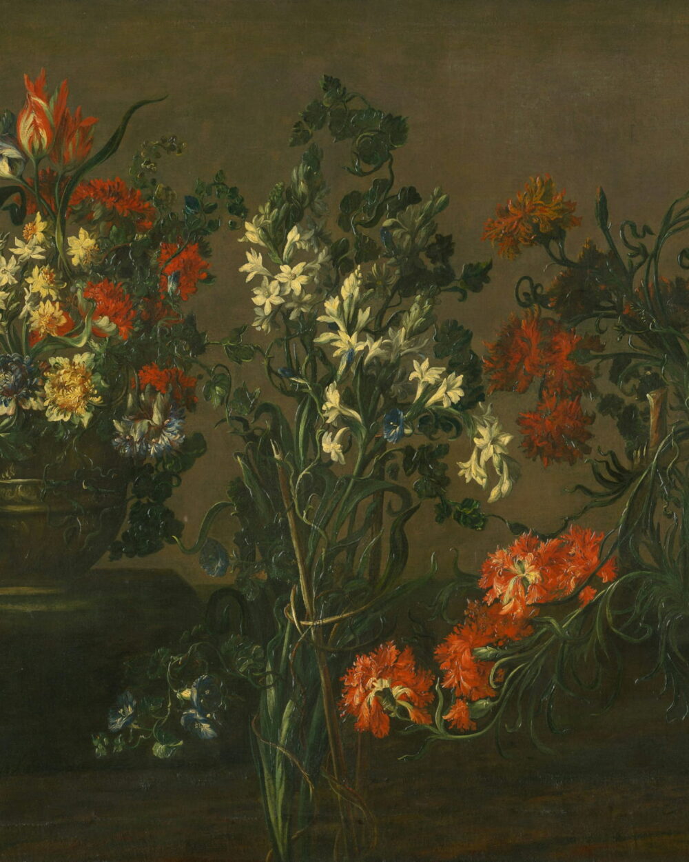 Orange lilies and white narcissus in a jar on a dark table.