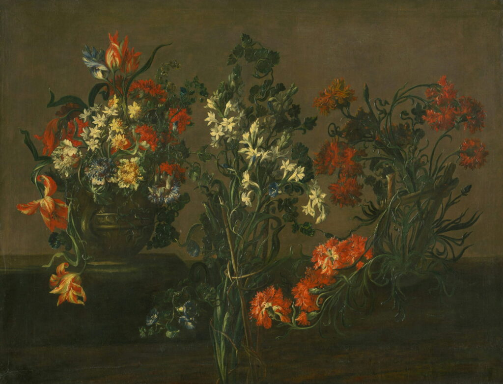 Orange lilies and white narcissus in a jar on a dark table.