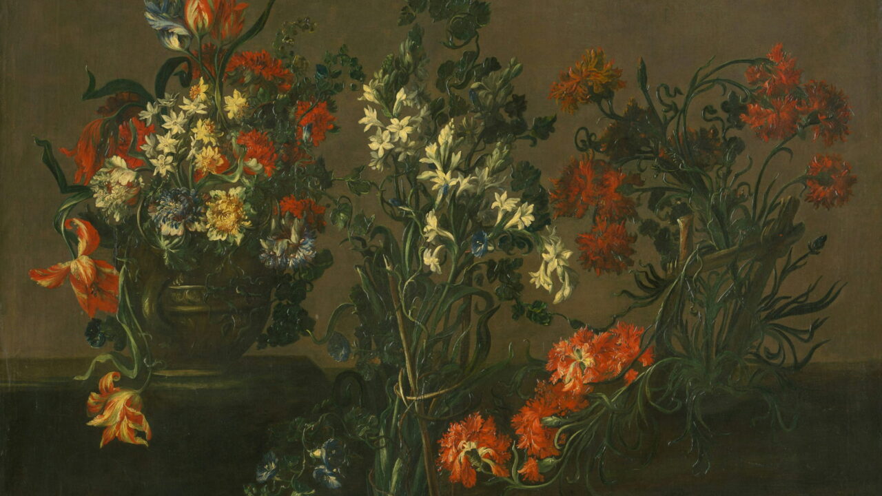 Orange lilies and white narcissus in a jar on a dark table.
