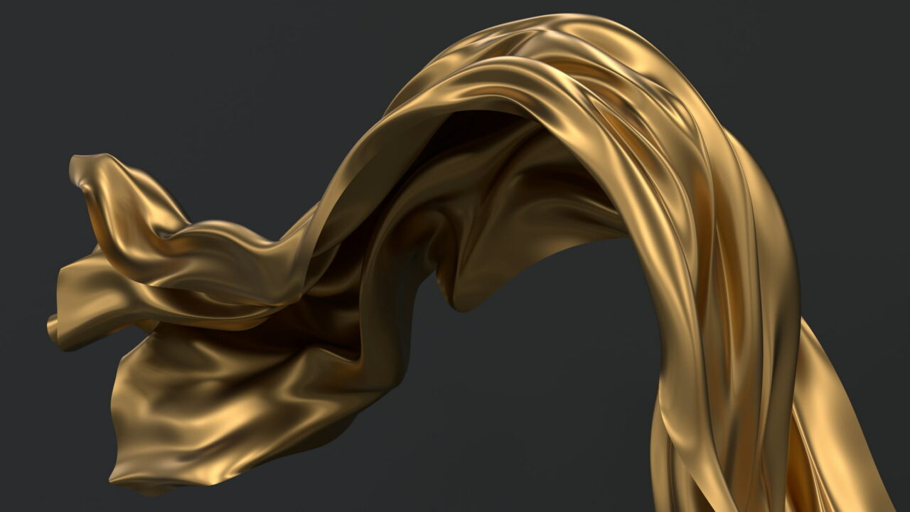 A sheet of gold cloth caught in the air against dark gray.