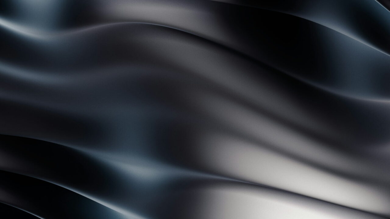 Black and silver waves rolling like silk across the frame.