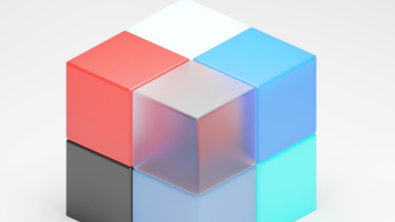 A cube made of red, blue, black, and frosted glass parts on white.