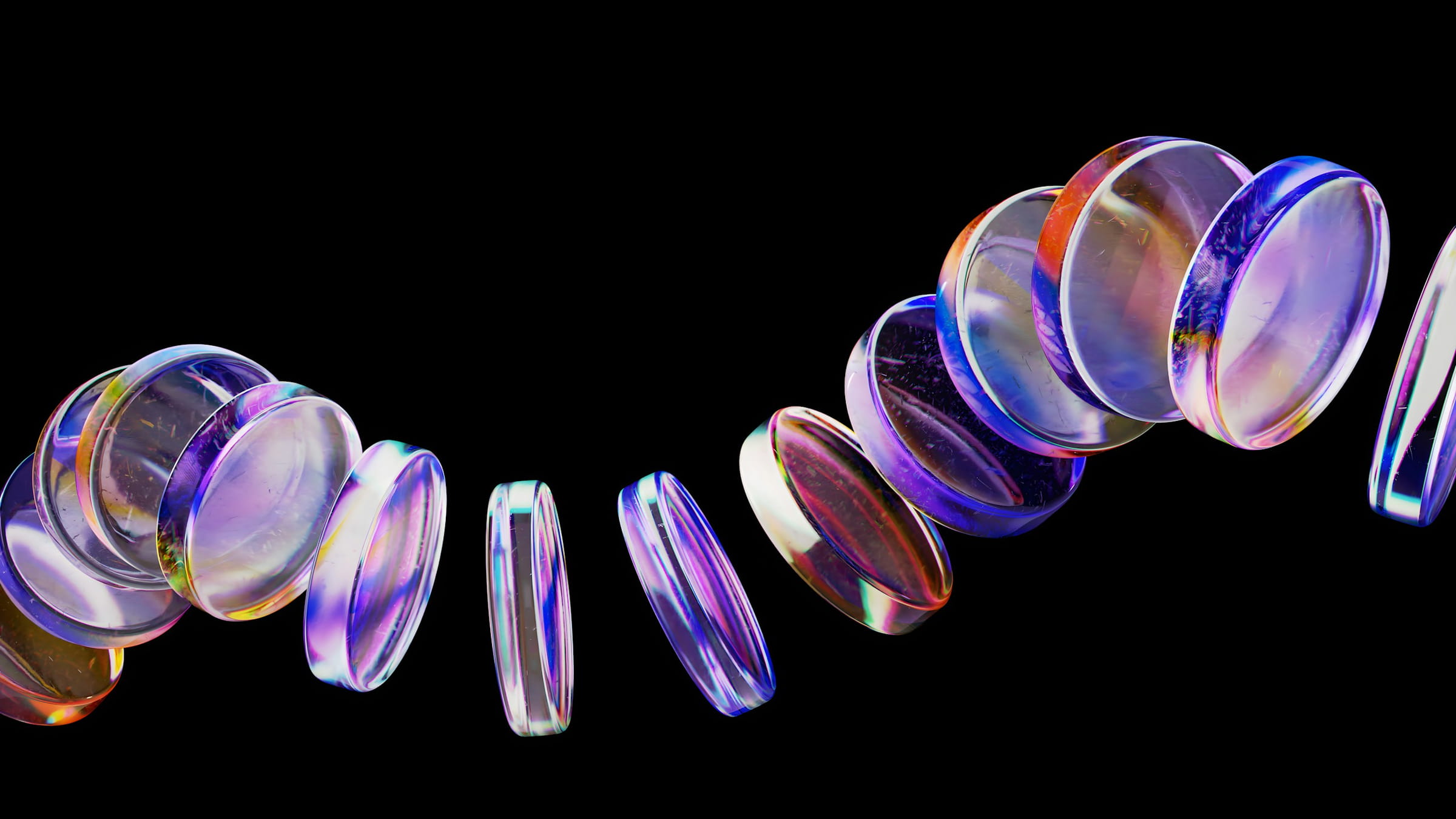 A curving chain of colored glass discs floating on black.