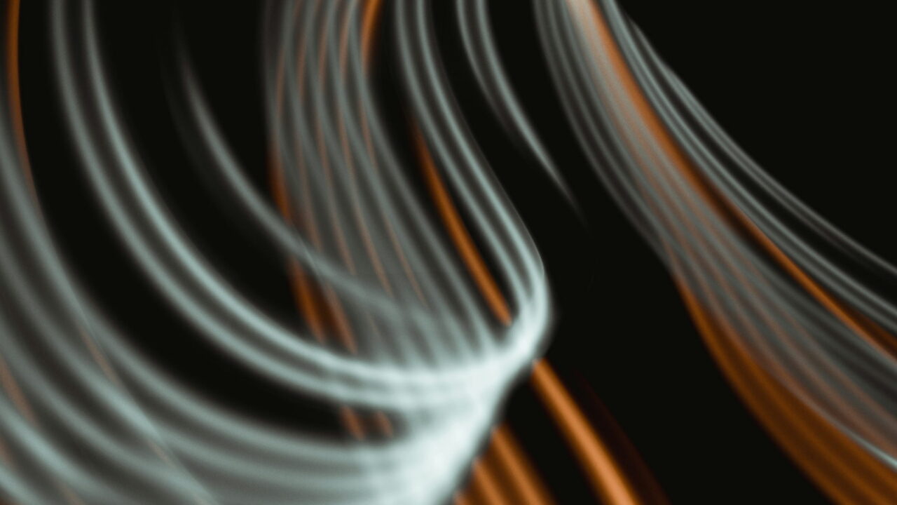 Pale and amber light trails sweeping in loose curves across a dark frame.