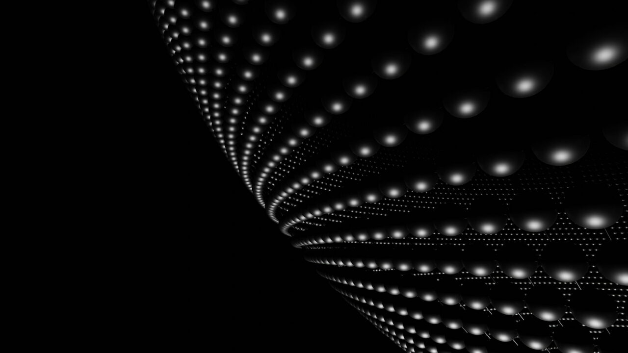 A curved wave of small white dots on black.