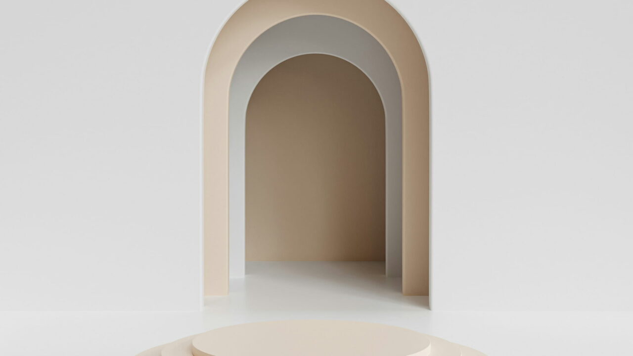 A pale stepped podium in front of a small arched doorway.