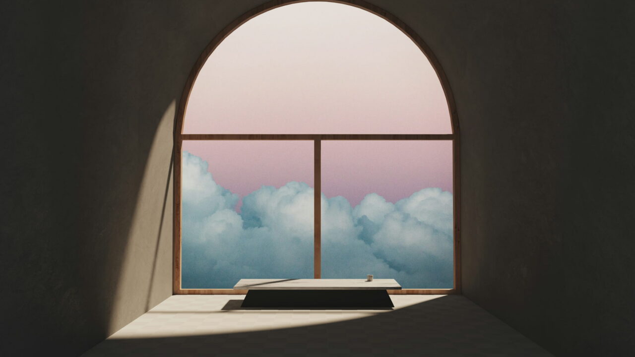 A dark room with an arched window full of clouds and a low bench in the light.