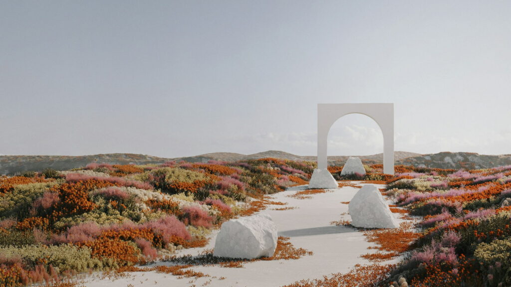 A white arch and pale stones on a path through red and orange flowers.