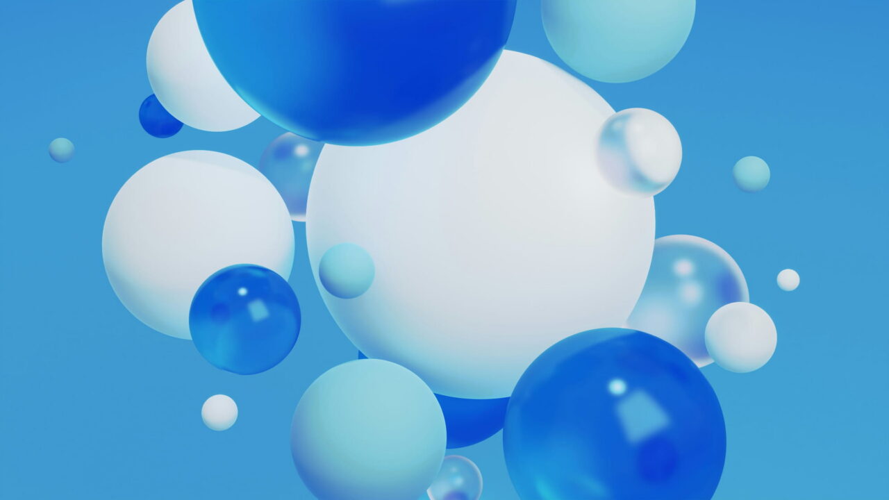 Blue, white, and clear spheres floating on bright blue.