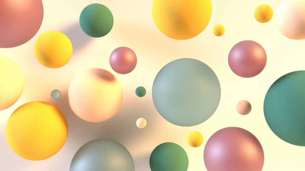 Pastel spheres in yellow, pink, and green floating on cream.