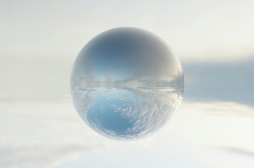 A glass ball resting on soft white cloud.